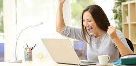 picture of excited woman in front of computer