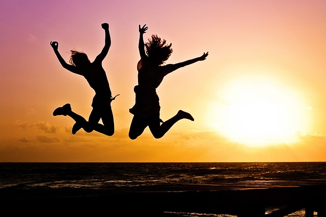 picture of two people having fun on beach during sunset