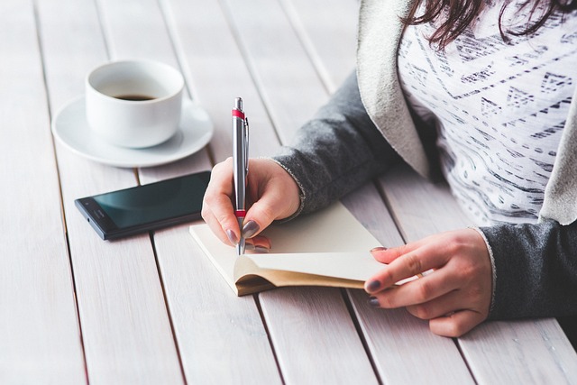 picture of somebody taking notes while having coffee